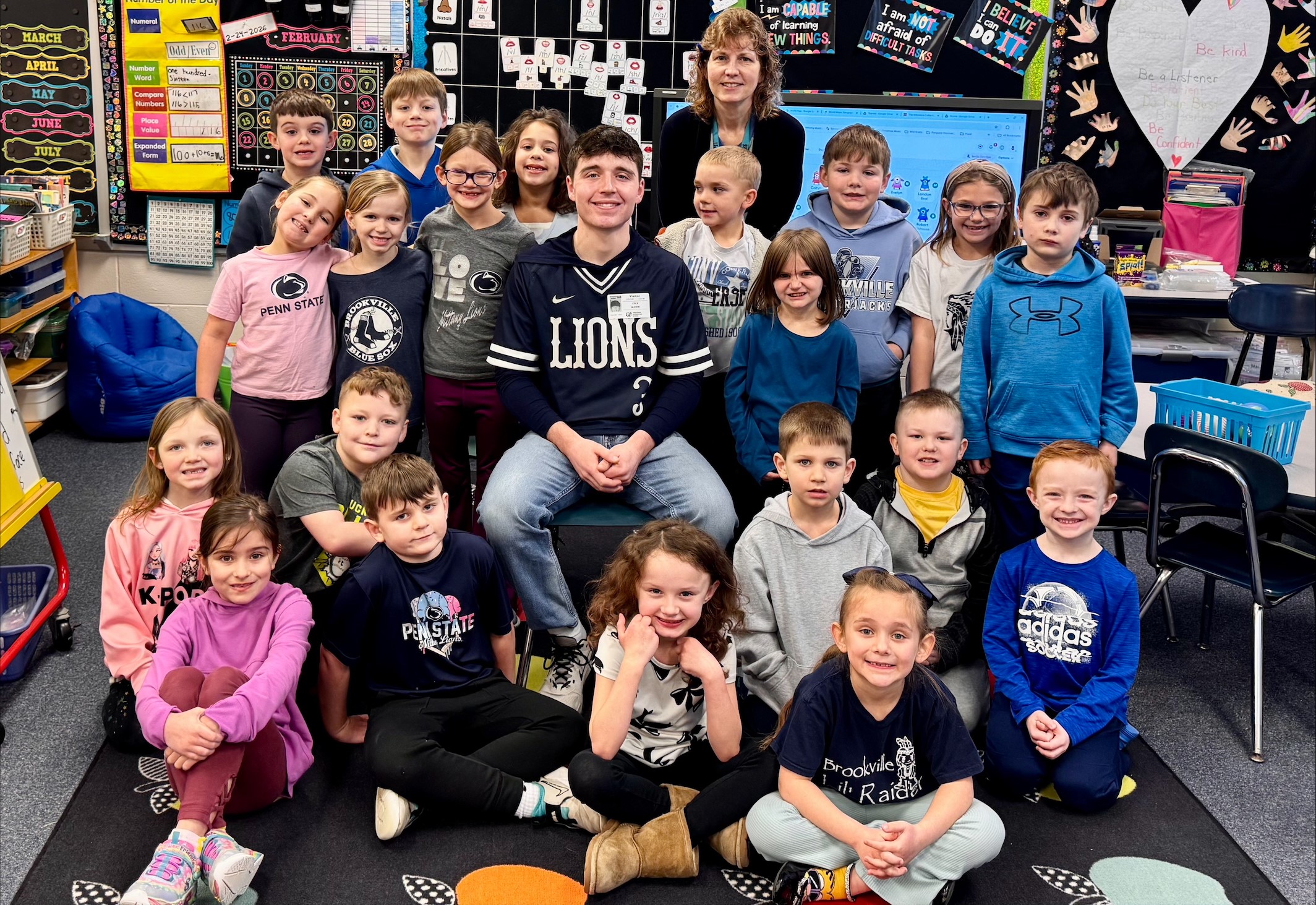 Penn State DuBois baseball player Cole Bloom poses for a photo with Mrs. Coleman and her students at Pinecreek Elementary.